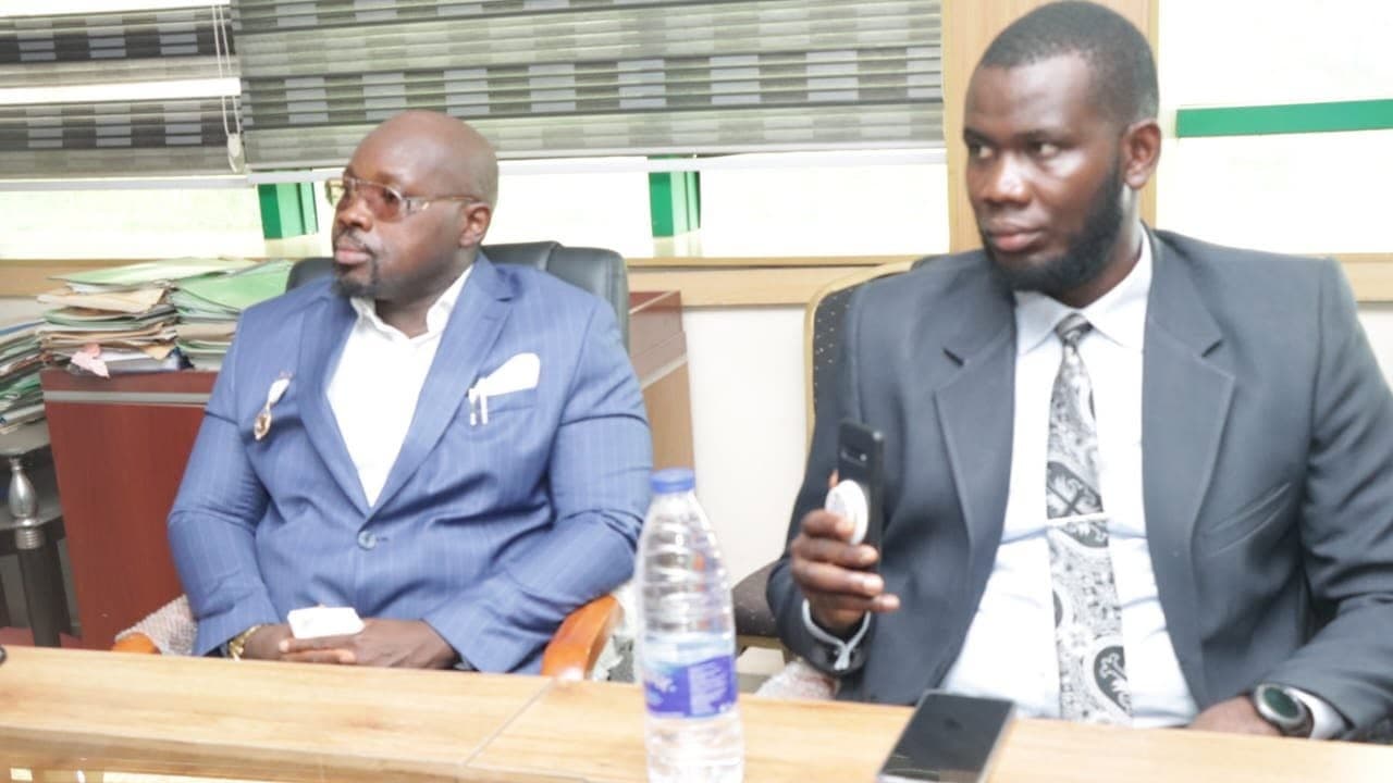 Two delegates seated at the conference table during the meeting.